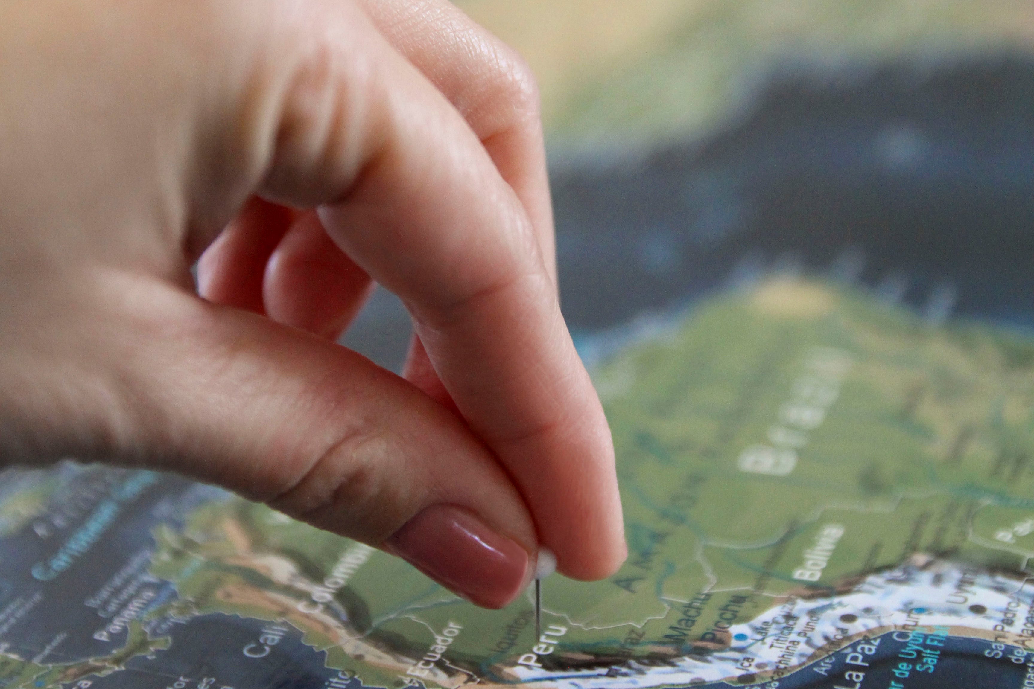 Person pinning a place the have been on a map