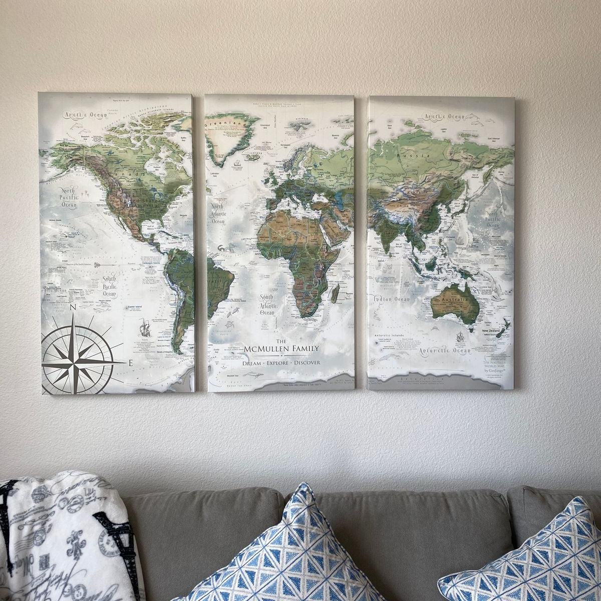travellers world map Three panel world push pin travel map hanging above a couch