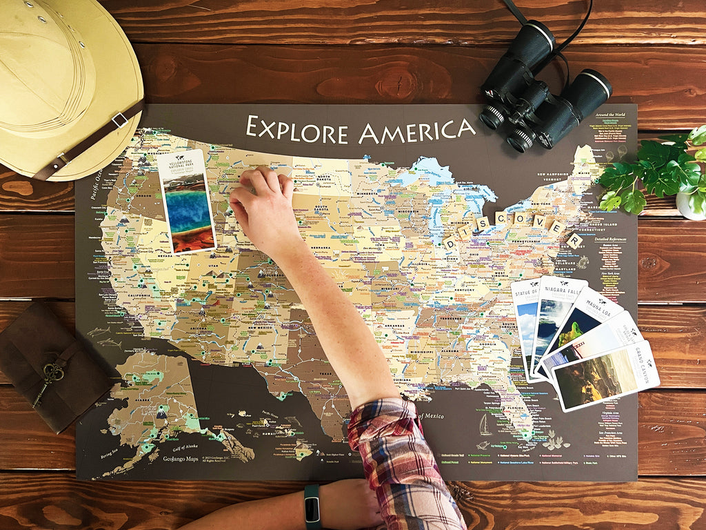 Person pinning a U.S. National Parks map