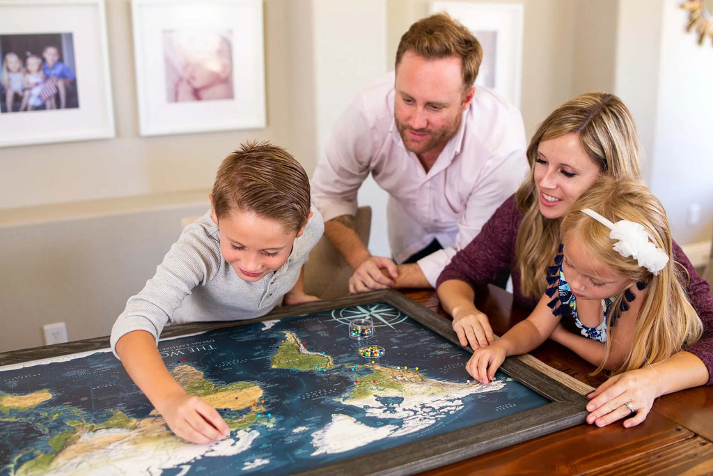 A family pinning their world travel map
