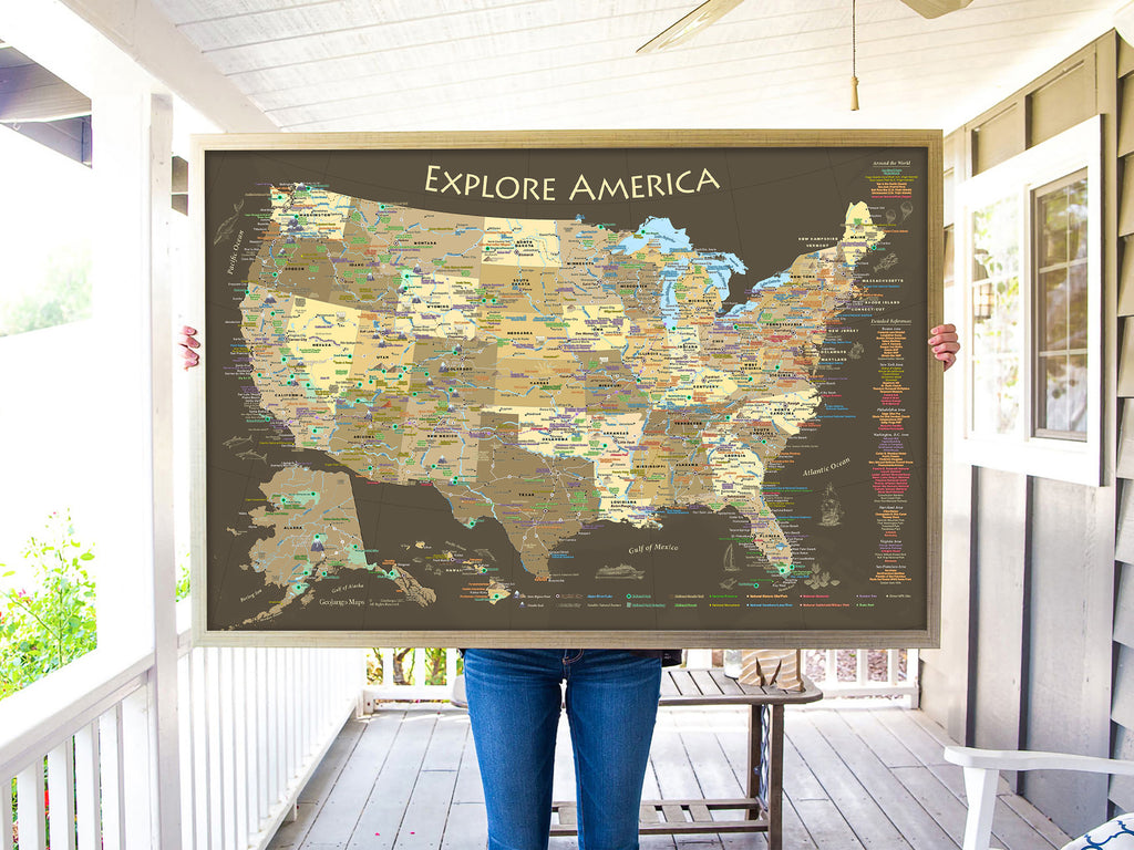 person holding a usa push pin map in gold frame